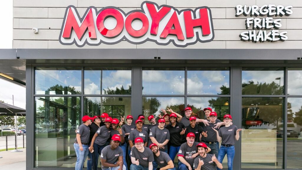 MOOYAH employees having fun in front of store
